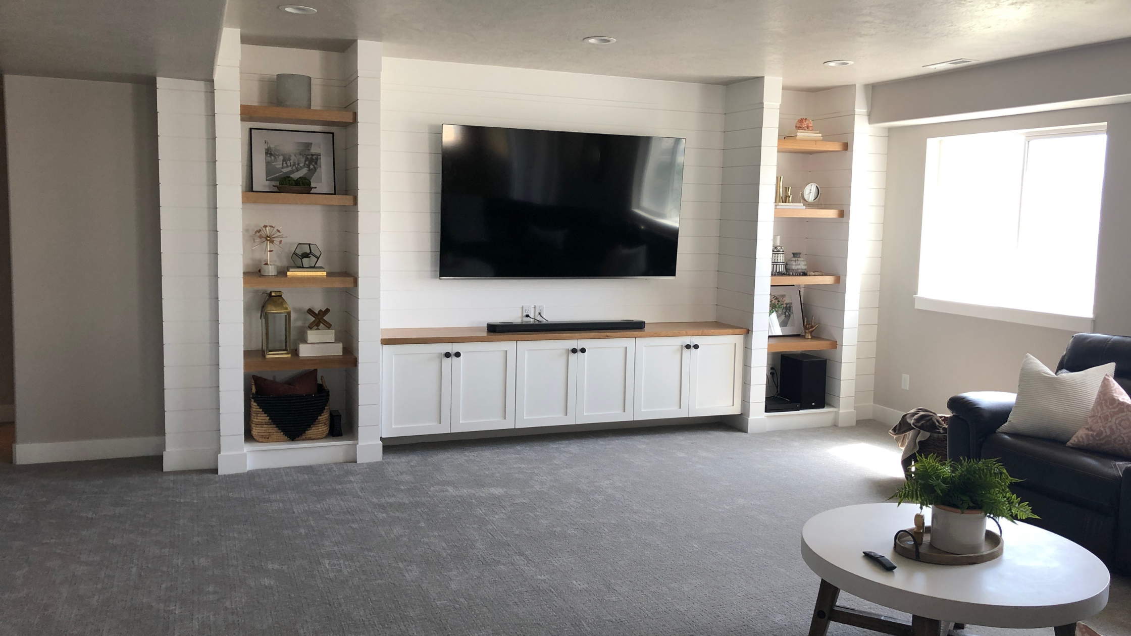 custom built ins with a fireplace and a modern white and wood style